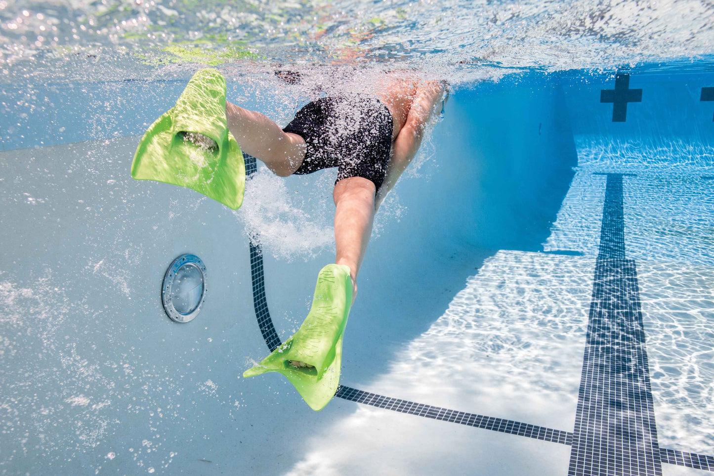 Child wearing FINIS Booster Swim Fins (Junior 8–11, Green) in pool