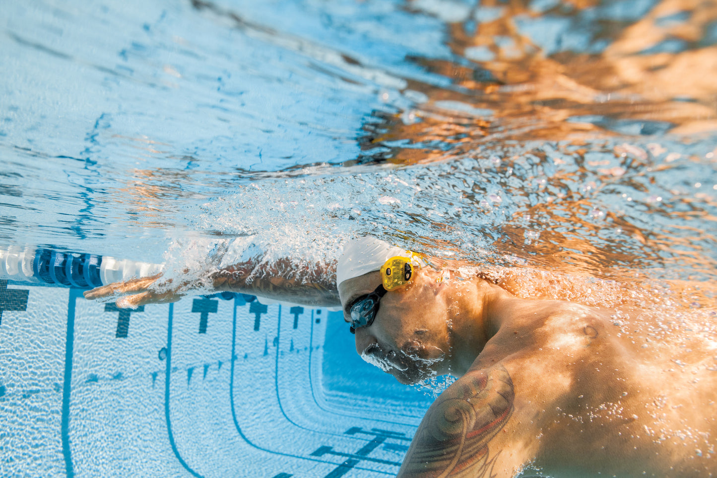 Underwater view of swimmer using FINIS Tempo Trainer Pro for tempo consistency