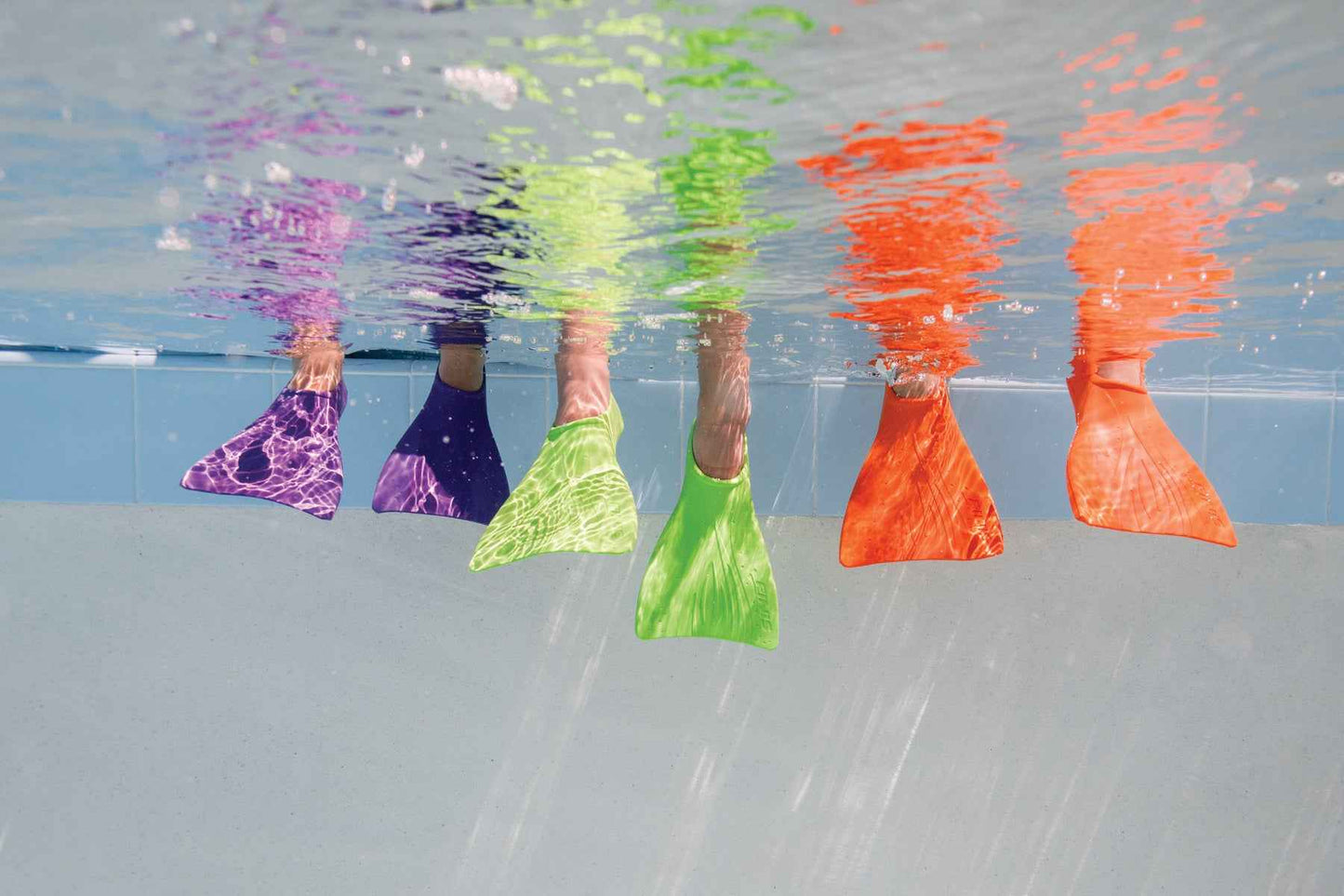 FINIS Booster Fins in multiple colours including purple, shown underwater in use
