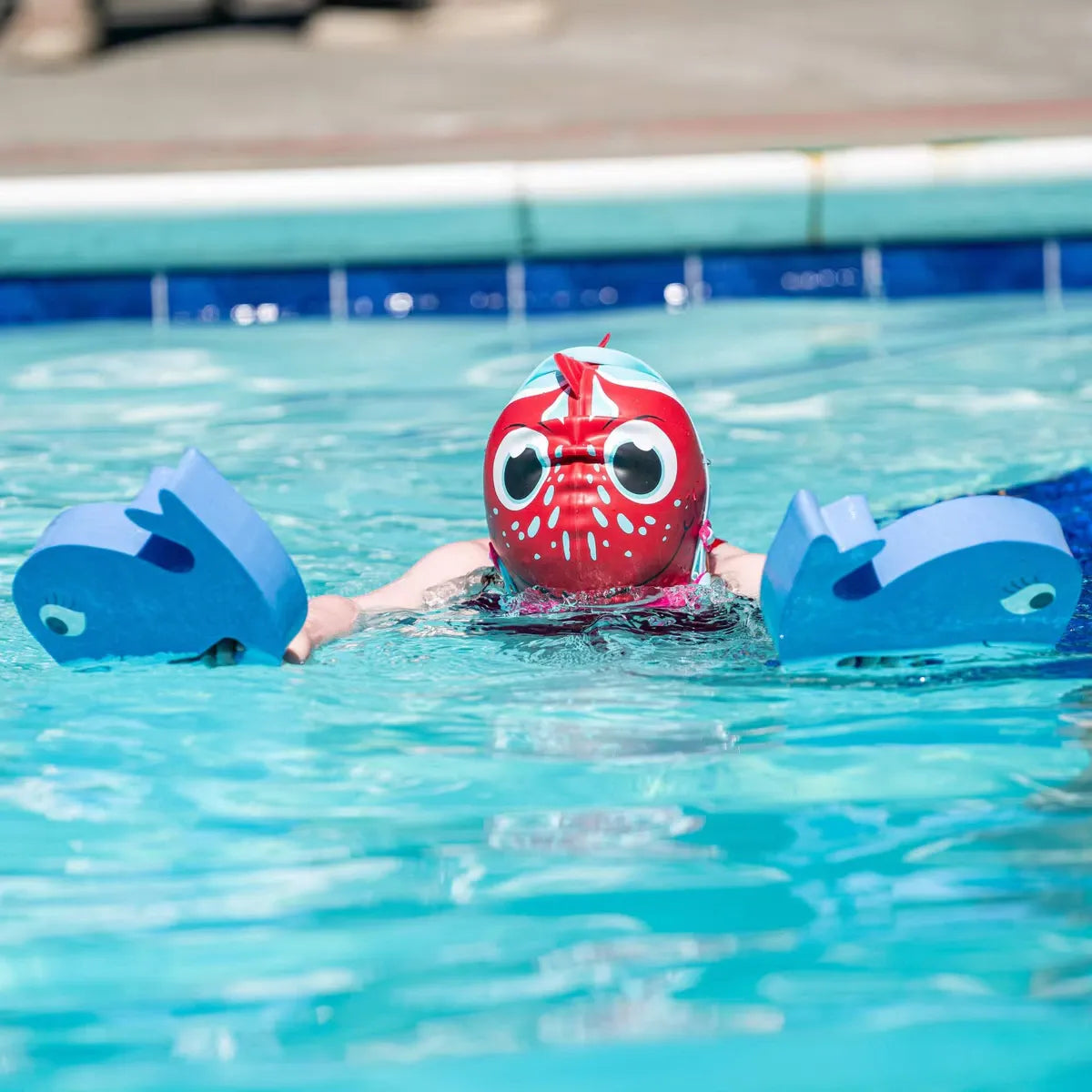 Swim class showing kids with FINIS Whale Blue hand floats.