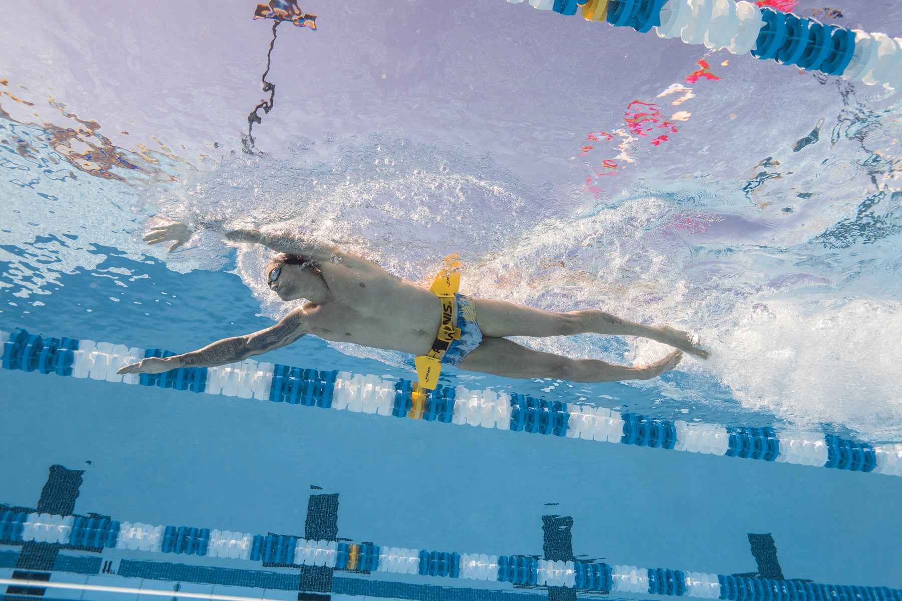 Side view of swimmer using FINIS Hydro Hip during freestyle stroke