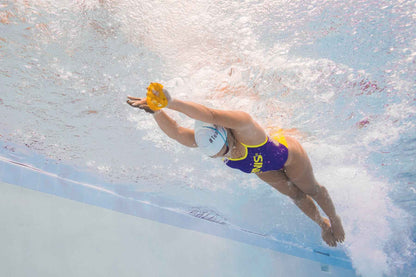 Top view showing FINIS Iso Paddles worn in two isolation positions on swimmer’s hands