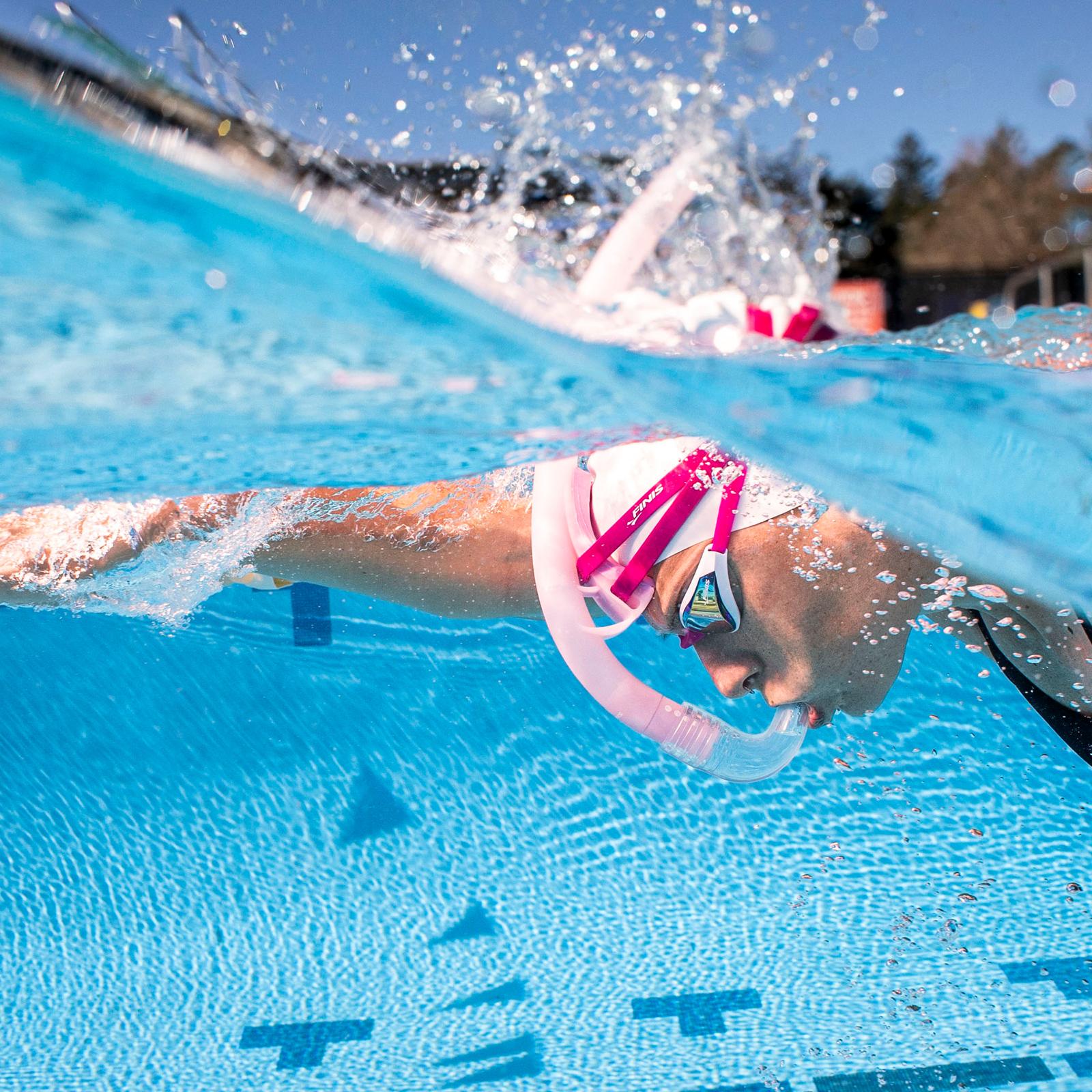 Swimmer using FINIS Stability Snorkel Orchid for technique training in pool