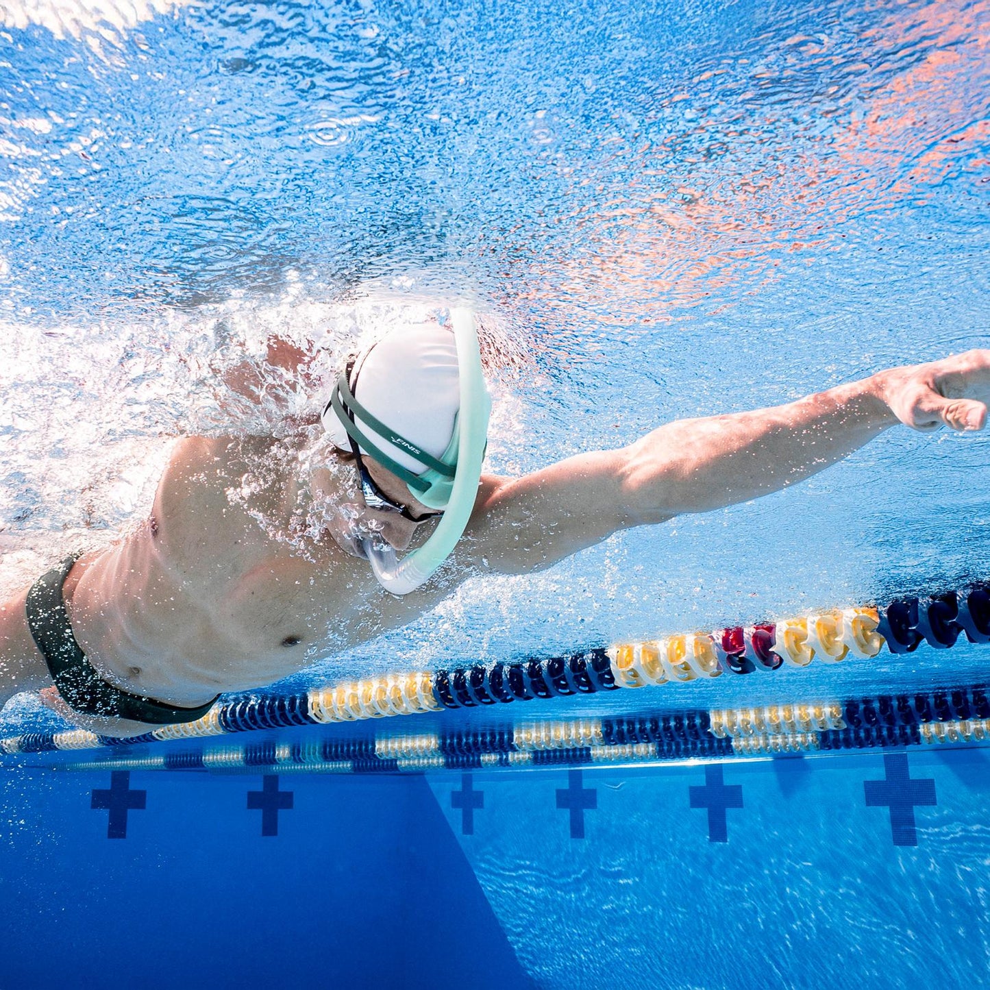 Swimmer using FINIS Stability Snorkel Sage during freestyle training to improve body alignment and stroke technique
