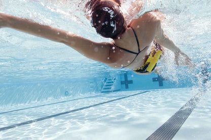 Close-up of FINIS Tech Toc in use during freestyle stroke training, poolside view